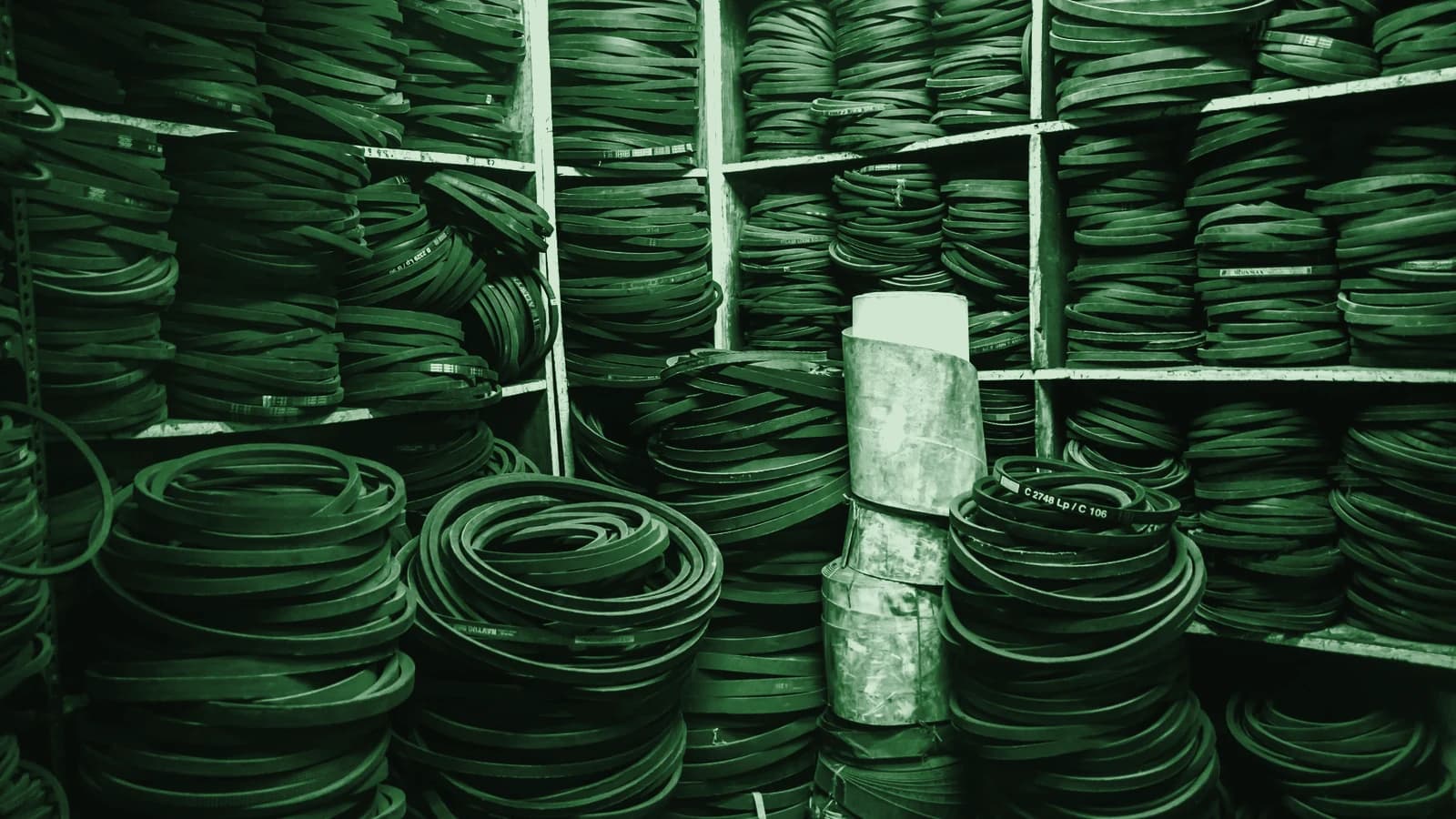 Belts and hoses stacked on shelving in a parts warehouse