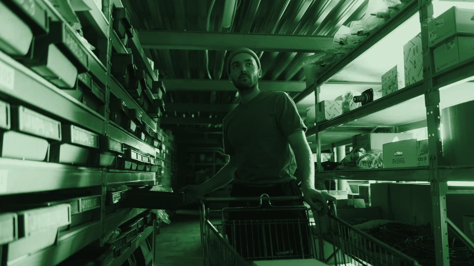 A storeman pulling stock from racking in an industrial parts store