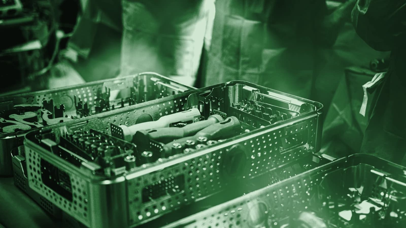 A sterile tray of medical instruments laid out on a bench